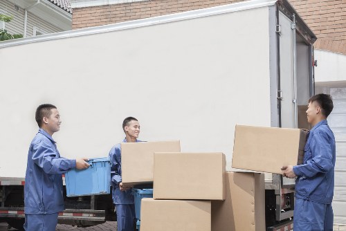 Moving team sorting recyclable boxes and packing materials in Shoreditch